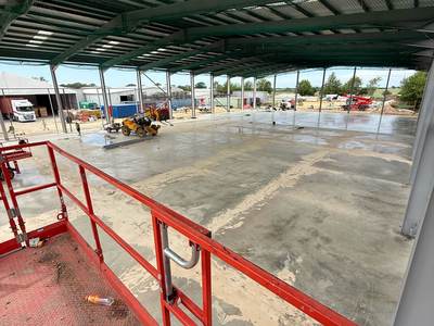 The finished slab seen from a raised work platform beneath the roof sheeting